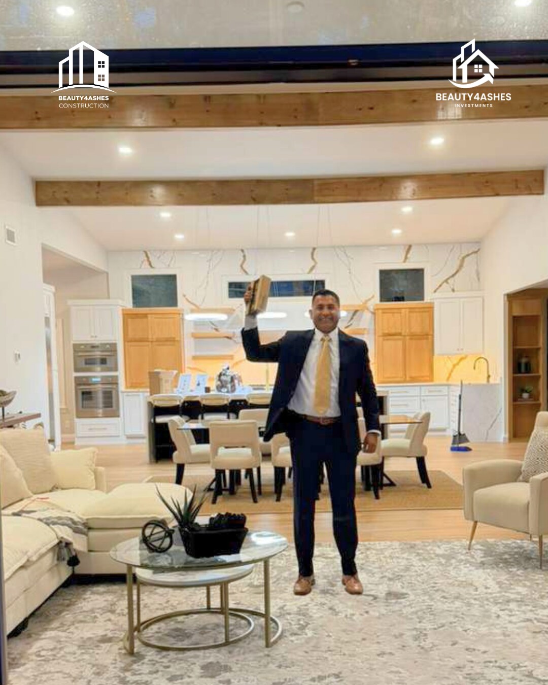 Beauty4Ashes founder holding the 2026 NWA Parade of Homes trophy overhead in the award-winning great room